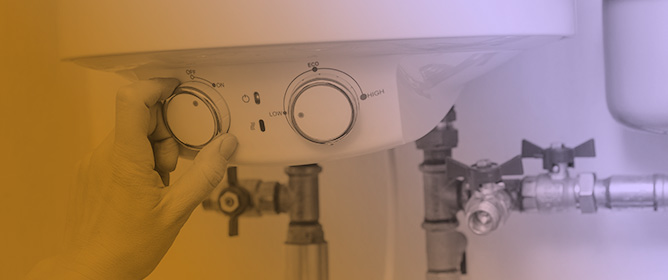 Model Predictive Control of Electric Water Heaters in Individual Dwellings Equipped with Grid-Connected Photovoltaic Systems